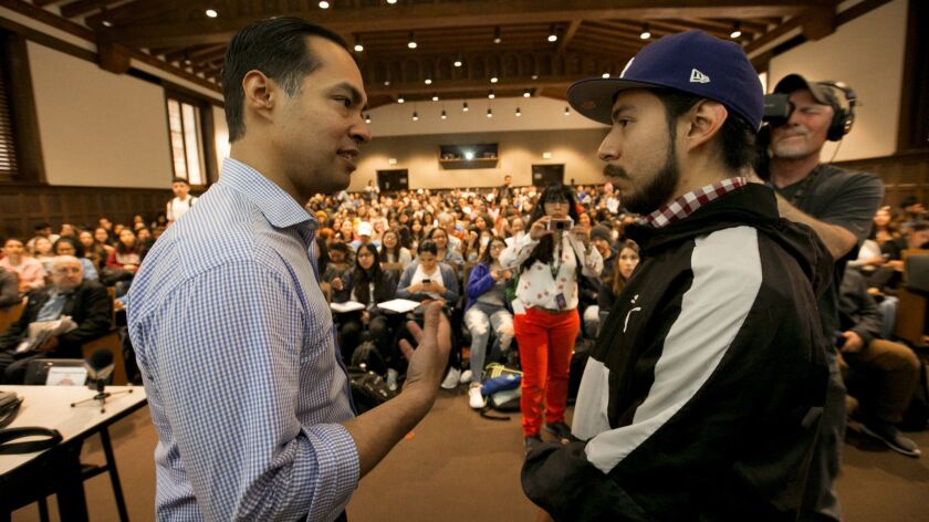 Democratic presidential candidate Julian Castro, left, speaks with Alejandro Juarez, 22, in a UCLA Chicano studies class on Monday.