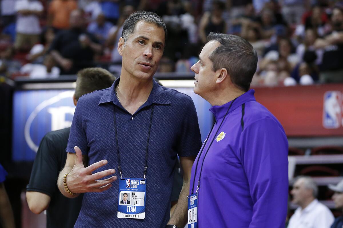 Rob Pelinka, left, chats with Lakers coach Frank Vogel during a Summer League game in Las Vegas.