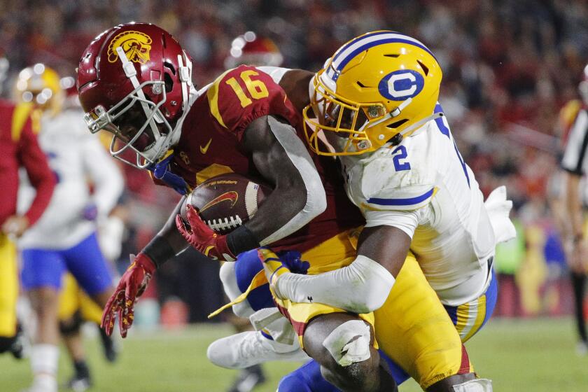 LOS ANGELES, CA - NOVEMBER 5, 2022: USC Trojans wide receiver Tahj Washington (16) is tackled by California Golden Bears.