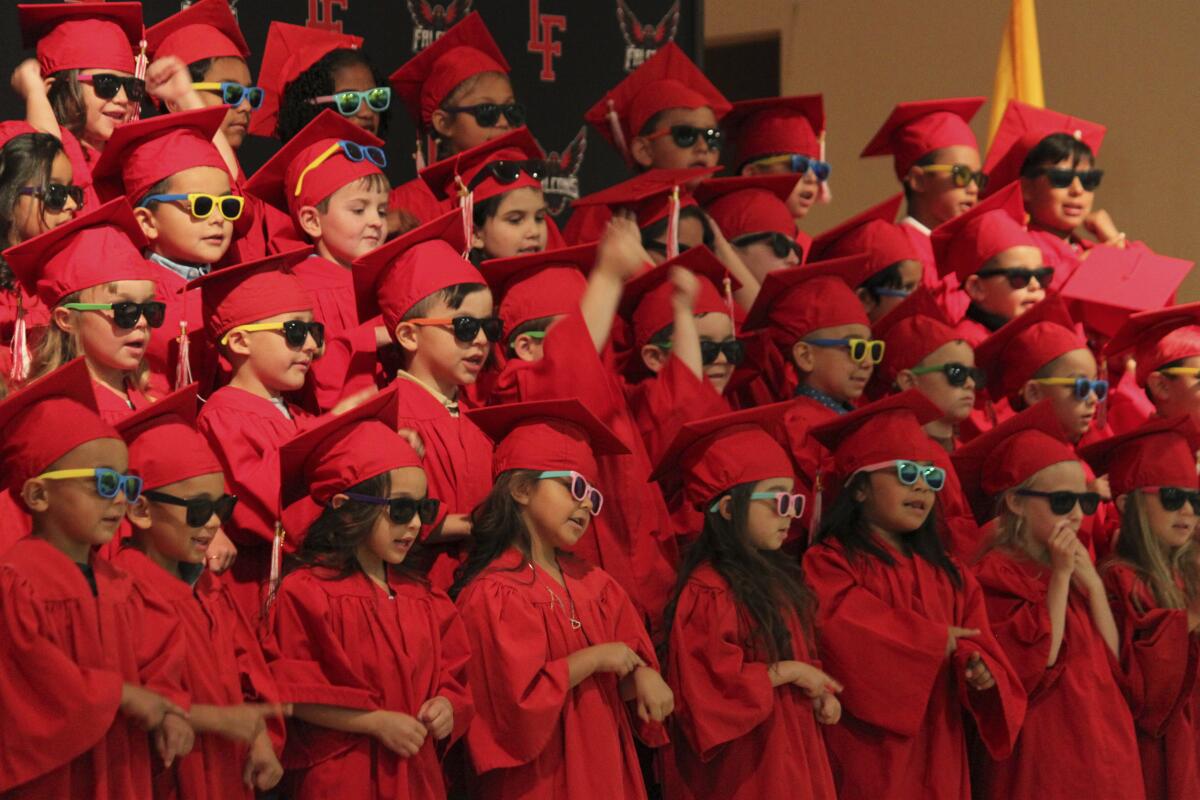 Kindergartners perform during their graduation