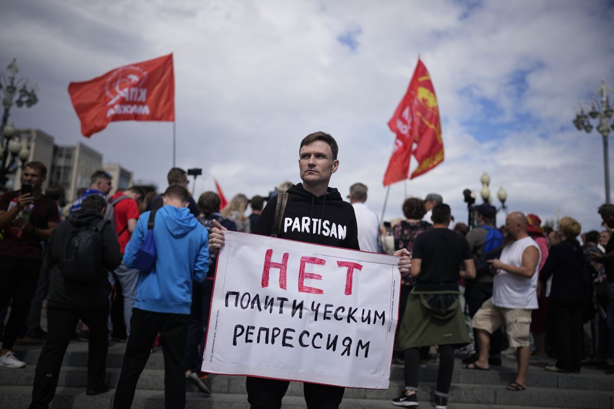 Demonstrator holding sign at anti-vaccination protest in Moscow