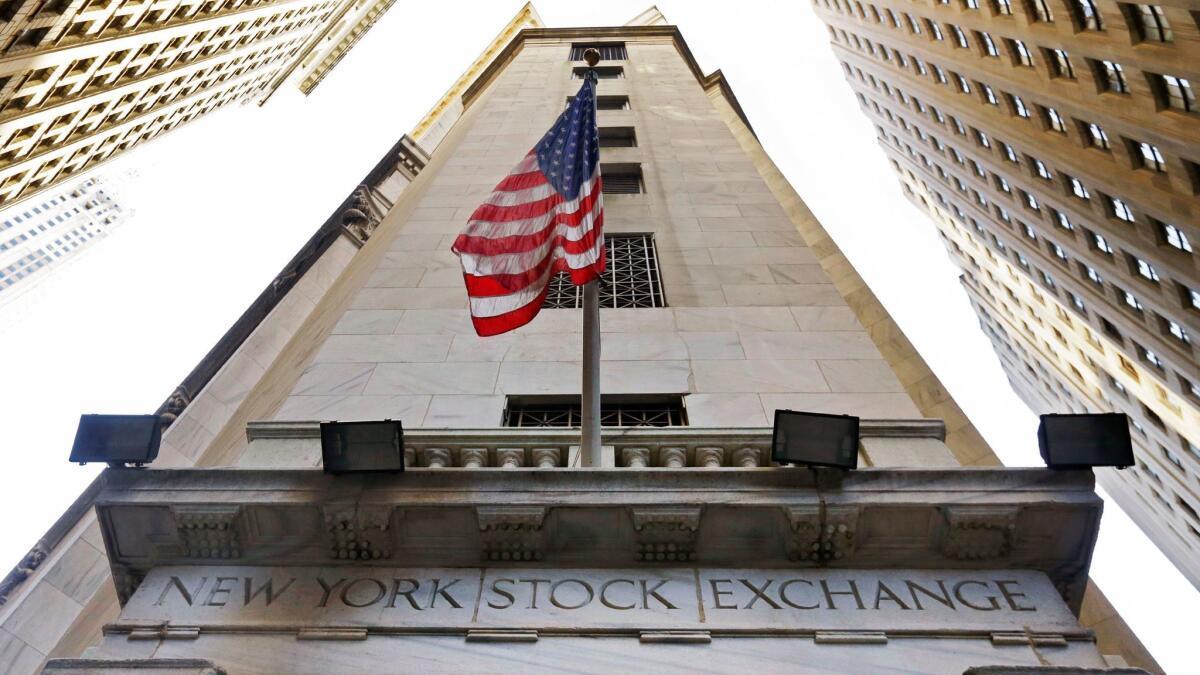 An American flag flies above the Wall Street entrance to the New York Stock Exchange.