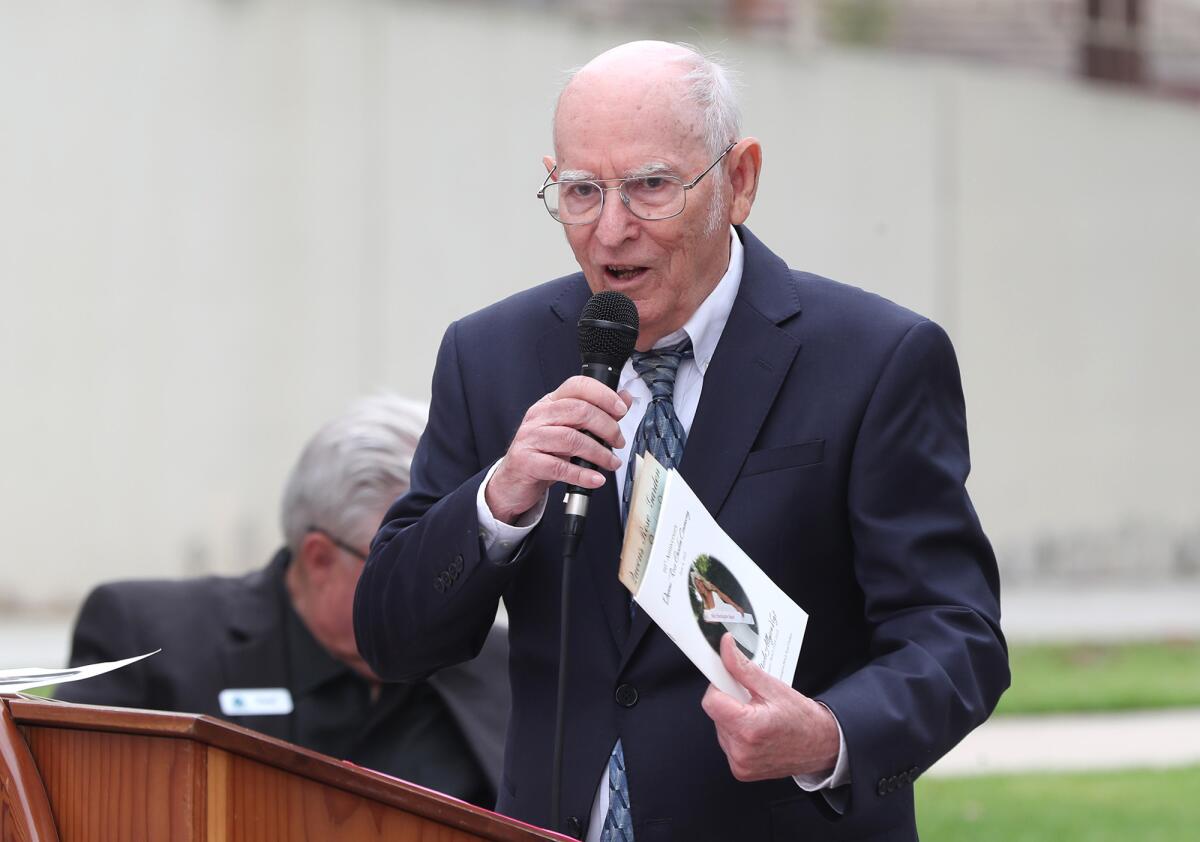Jim Sankey talks about the history of the Queen's Rose Garden at Huntington Beach City Hall on Friday morning.