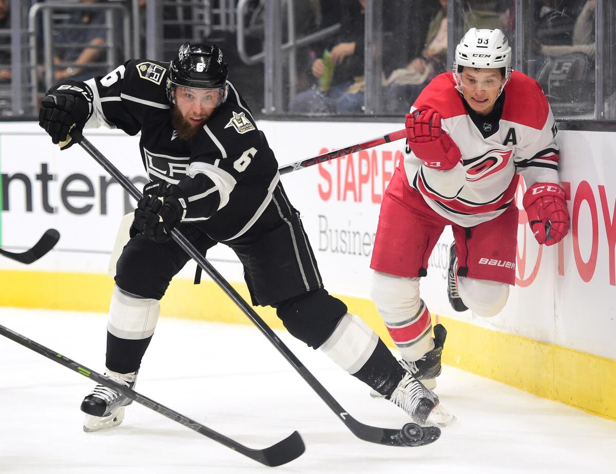 Kings defenseman Jake Muzzin (6) clears the puck as he is chased by Hurricanes' Jeff Skinner (53) during a game on Dec. 8, 2016.