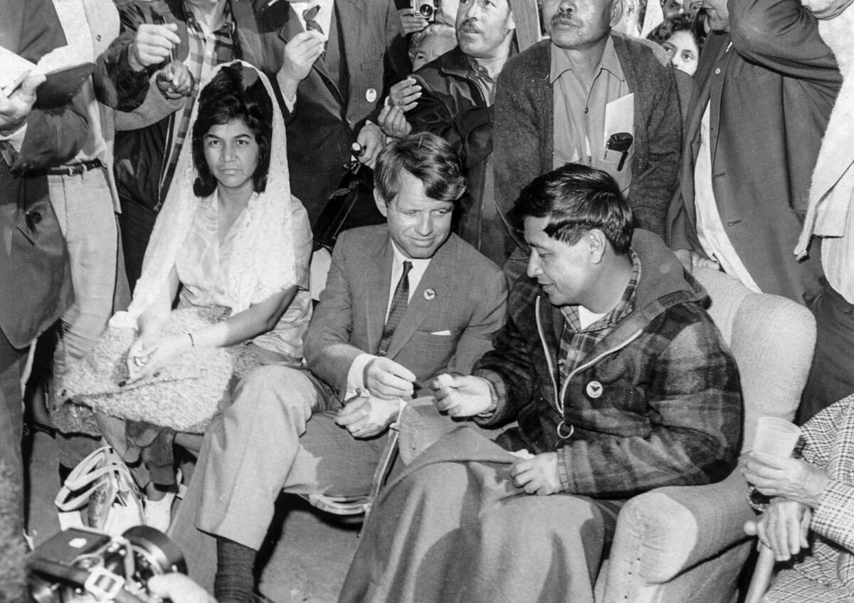 March 10, 1968: Sen. Robert F. Kennedy offers Chavez food during a special Mass in Delano attended by 6,000 people. Chavez ended a 25-day fast that he had undertaken to rededicate the farmworkers' movement to nonviolence. His wife, Helen Chavez, is at left.