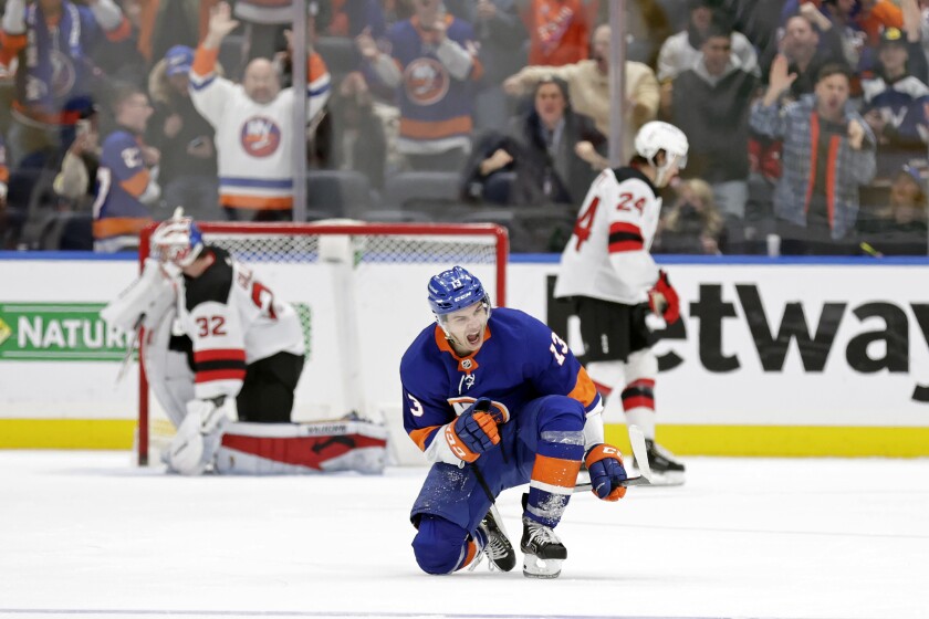 New York Islanders center Mathew Barzal (13) reacts after scoring the game winning goal past New Jersey Devils goaltender Jon Gillies in the third period of an NHL hockey game Thursday, Jan. 13, 2022, in Elmont, N.Y. The Islanders won 3-2. (AP Photo/Adam Hunger)