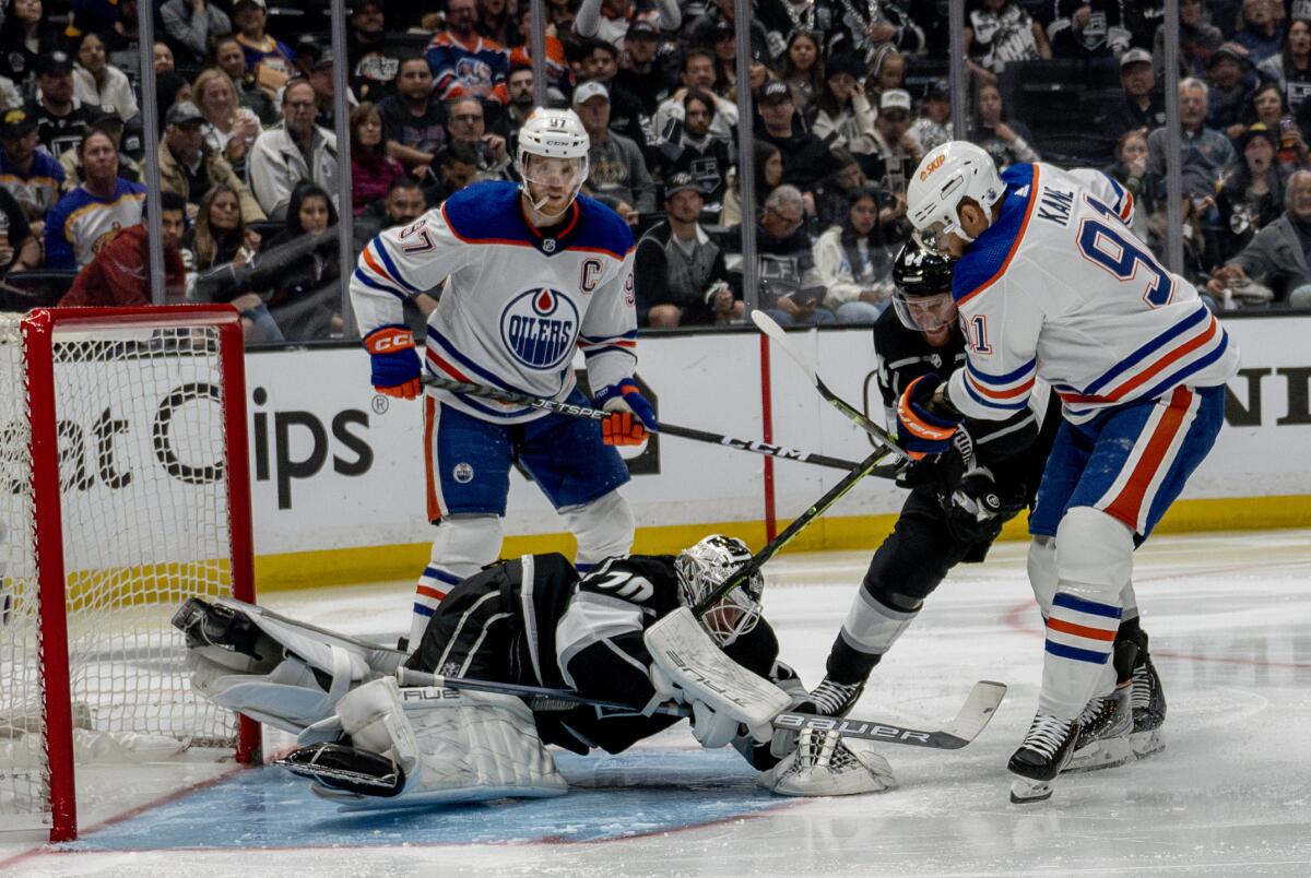 Kings goaltender Joonas Korpisalo blocks a shot by Edmonton Oilers forward Evander Kane.
