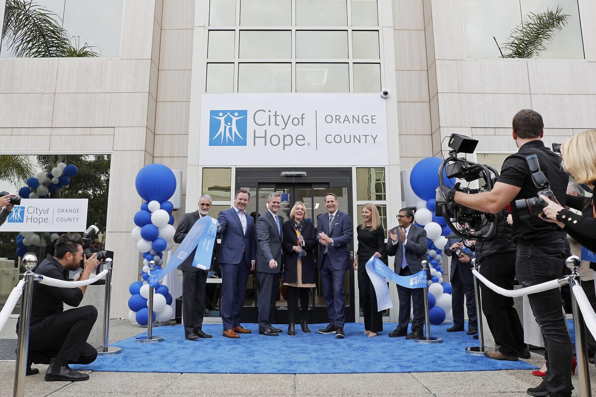 Officials attend a ribbon during the grand opening for City of Hope in Newport Beach.