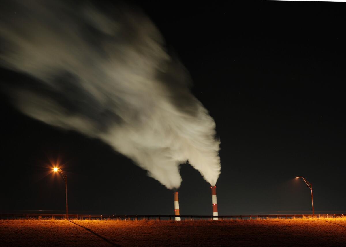 Increased coal use in 2013 helped push carbon dioxide emissions up 2% last year compared with 2012, a report says. Above, a coal-fired power plant in Kansas.
