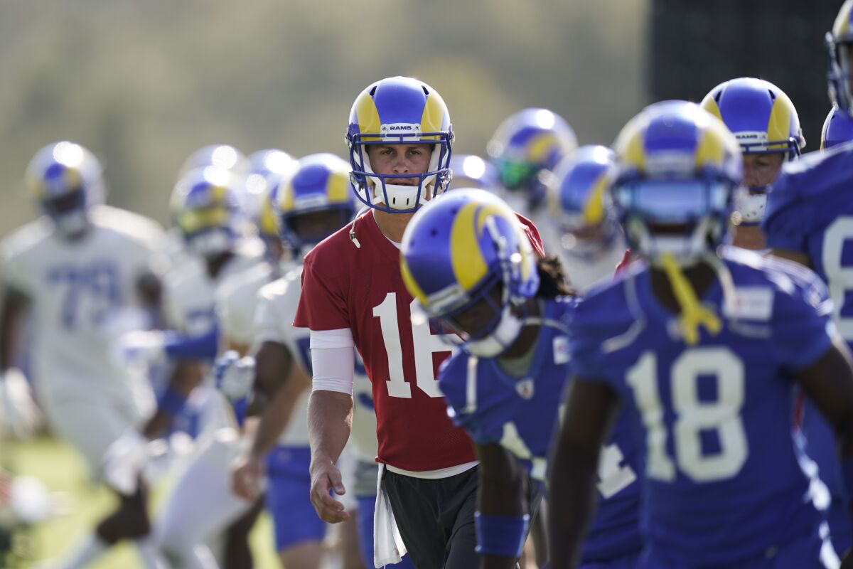 Los Angeles Rams quarterback Jared Goff, center, warm up with teammates during an NFL football camp practice Thursday, Aug. 27, 2020, in Thousand Oaks, Calif. (AP Photo/Jae C. Hong)