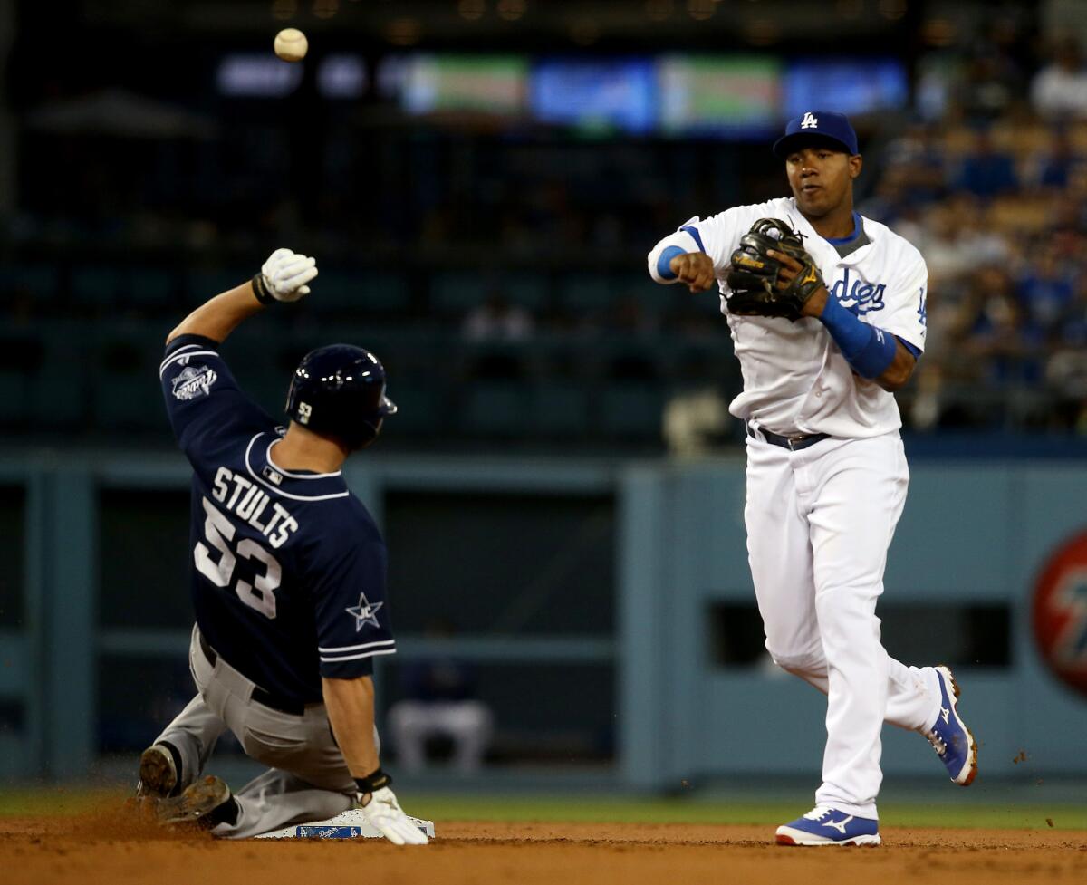 Dodgers shortstop Erisbel Arruebarrena turns a double play over Padres pitcher Eric Stults on Aug. 20.