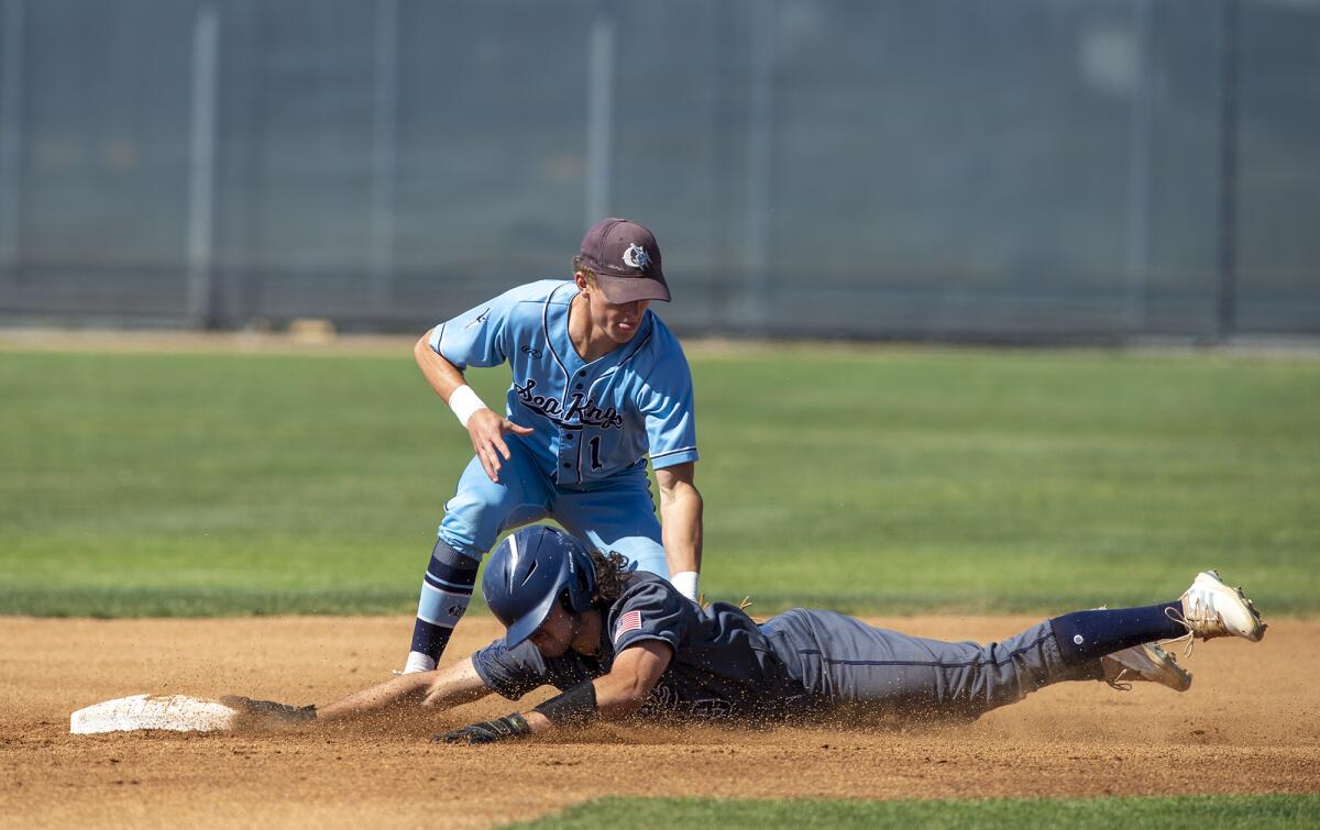 Newport Harbor's A.J. Guitron-Moore slides under the tag at second against Max Lane during a Wave League game on Thursday.