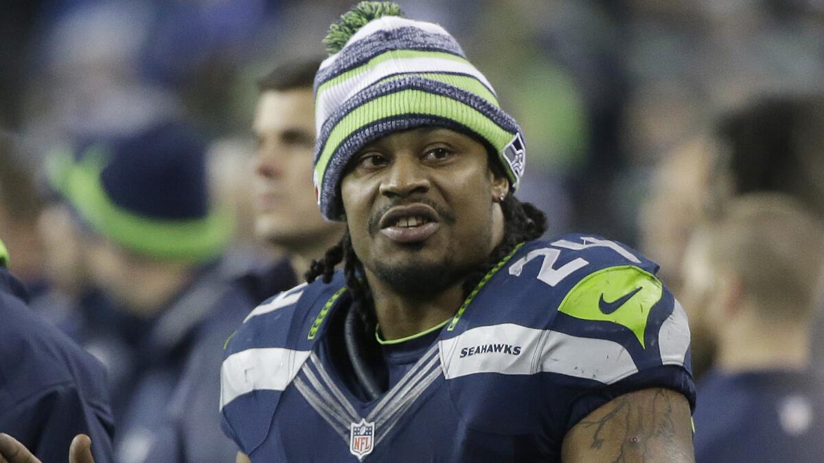 Seattle Seahawks running back Marshawn Lynch watches from the sideline during a 31-17 NFC divisional playoff win over the Carolina Panthers on Saturday.