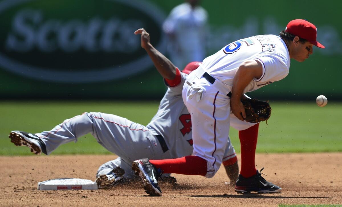 Angels second baseman Howie Kendrick slides safely into second base on a steal as Rangers second baseman Ian Kinsler fields the throw in the second inning Friday.