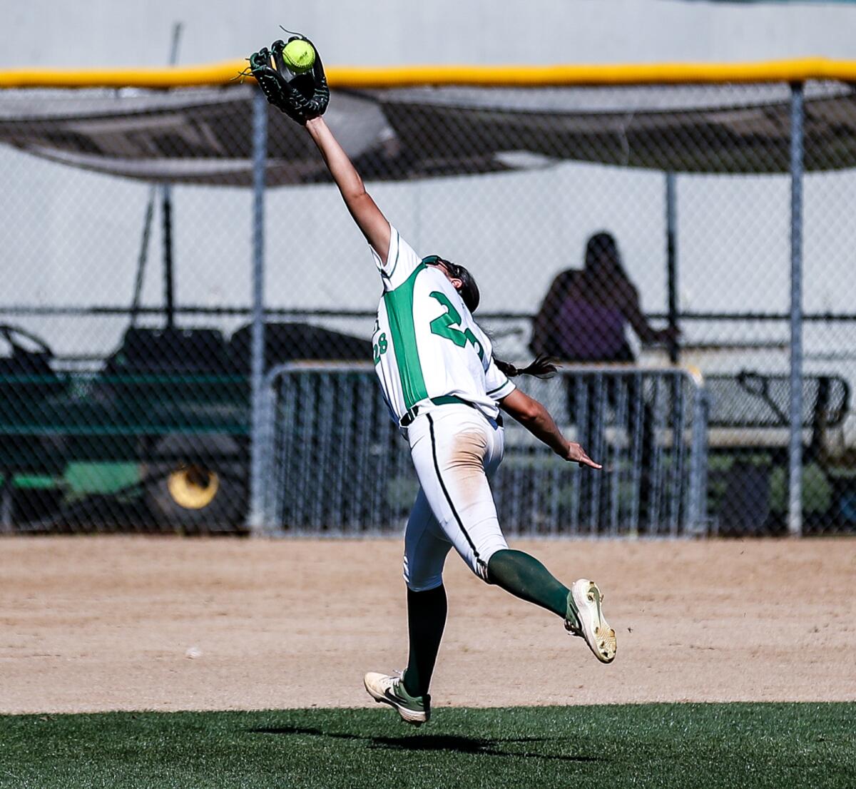 Center fielder Jeniece Jimenez of Granada Hills makes a running catch of a fly ball during her team's 6-0 win over ECR.