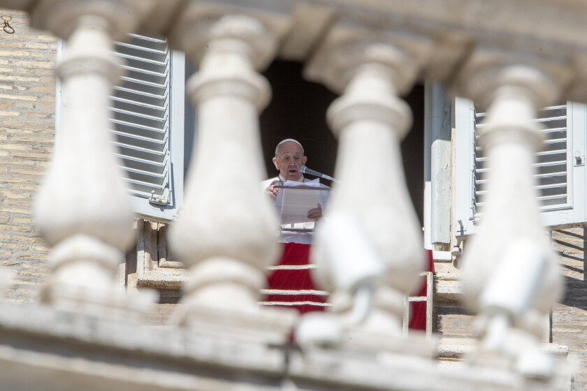 Pope Francis delivers his blessing as he recites the Angelus noon prayer from the window of his studio overlooking St.Peter's Square, at the Vatican, Sunday, Feb. 14, 2021. (AP Photo/Andrew Medichini)