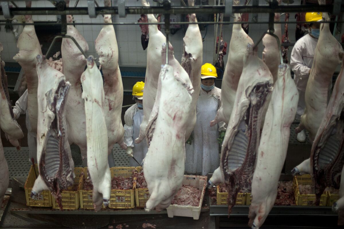 Workers at a pork processing plant in central China's Henan province in 2013. 