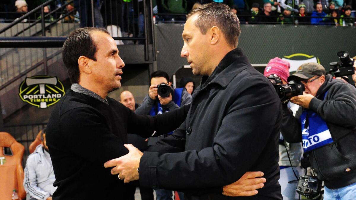 Head coach Oscar Pareja of FC Dallas (left) and head coach Caleb Porter of the Portland Timbers (right) greet each other before the match at Providence Park on November 22, 2015 in Portland, Oregon.