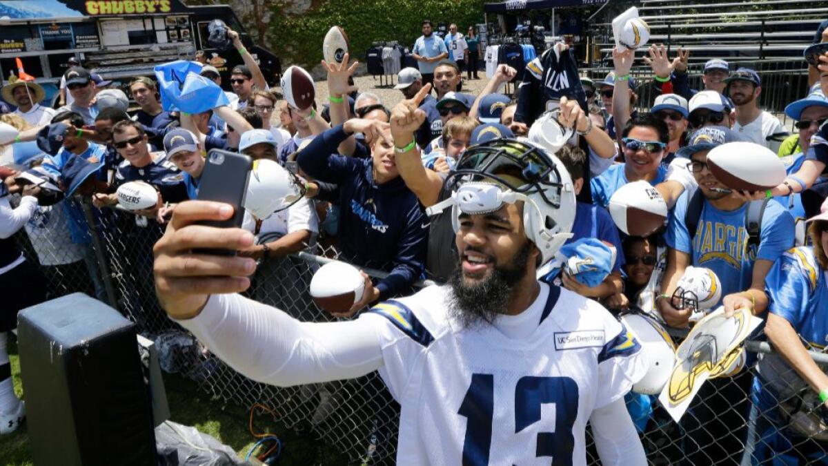 Chargers receiver Keenan Allen takes a selfie with a fan's phone after the team's minicamp practice on June 14.
