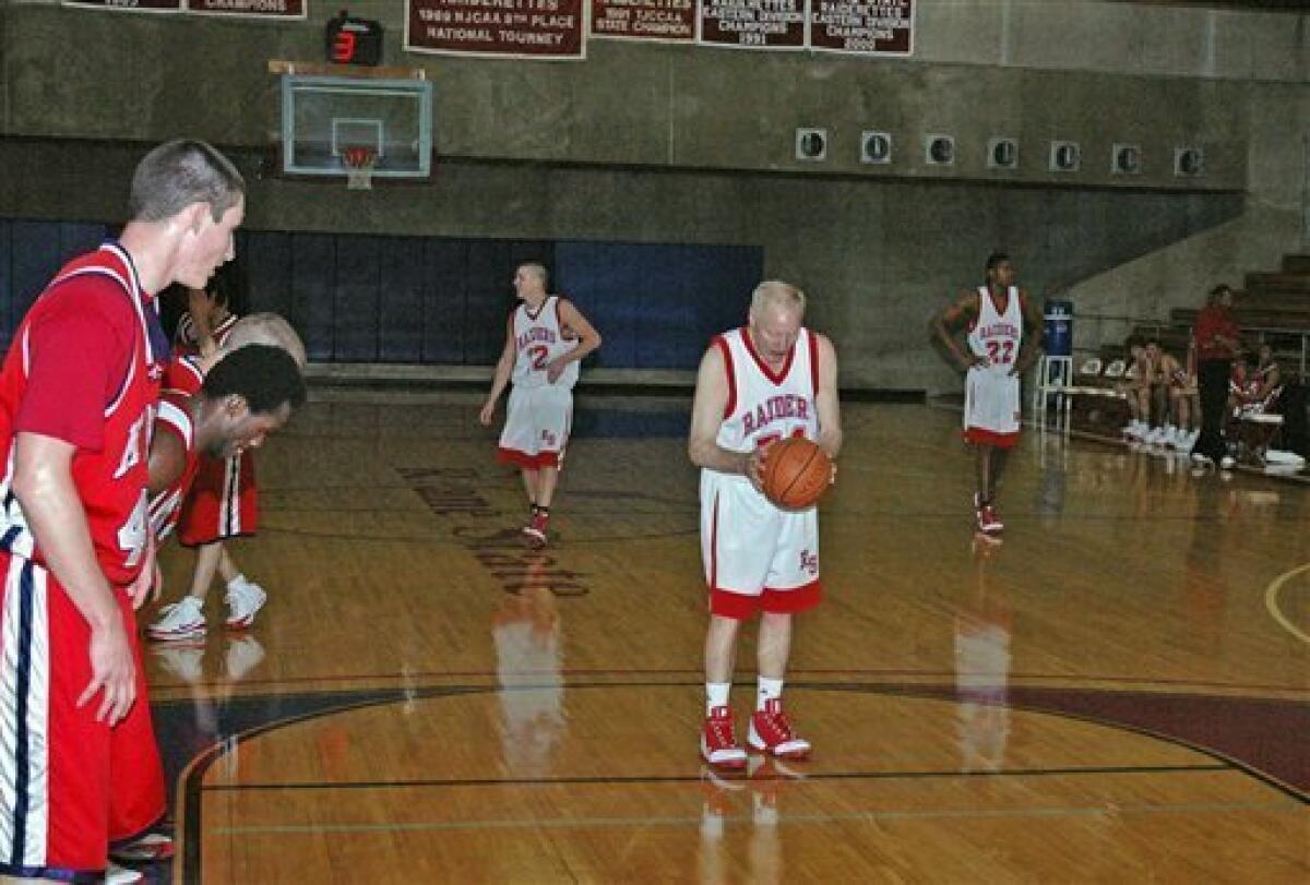 In a photo provided by Roane State Community College, Ken Mink, 73, prepares to shoot a free throw for Roane State in the team's 93-42 win over King College's junior varsity team in a basketball game Monday night, Nov. 3, 2008, in Harriman, Tenn. Mink scored two points on free throws. Roane State says Mink became the oldest person to play college basketball. (AP Photo/Roane State Community College, Owen Driskill)