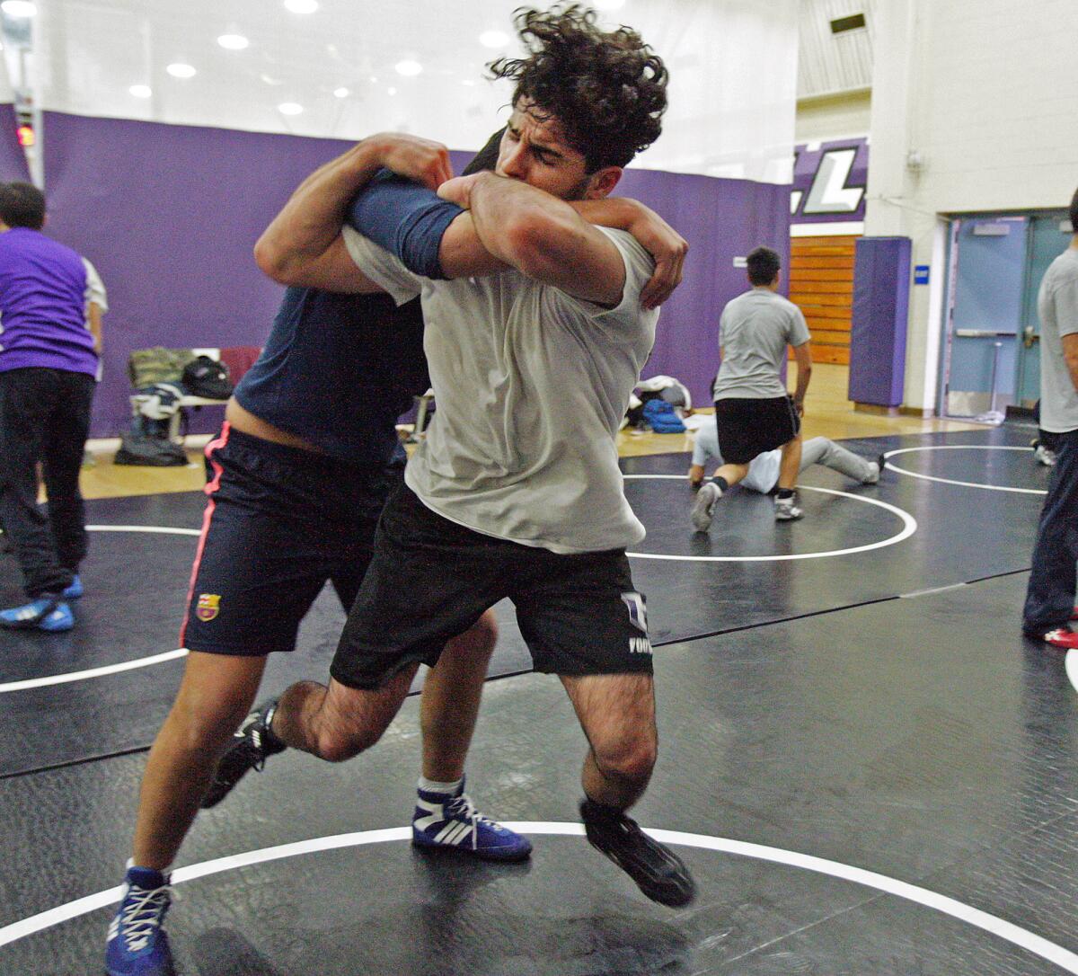 Hoover's Davit Nersisyan practices a wrestling technique with a partner at wrestling practice at Hoover High School in Glendale on Monday, December 1, 2014.