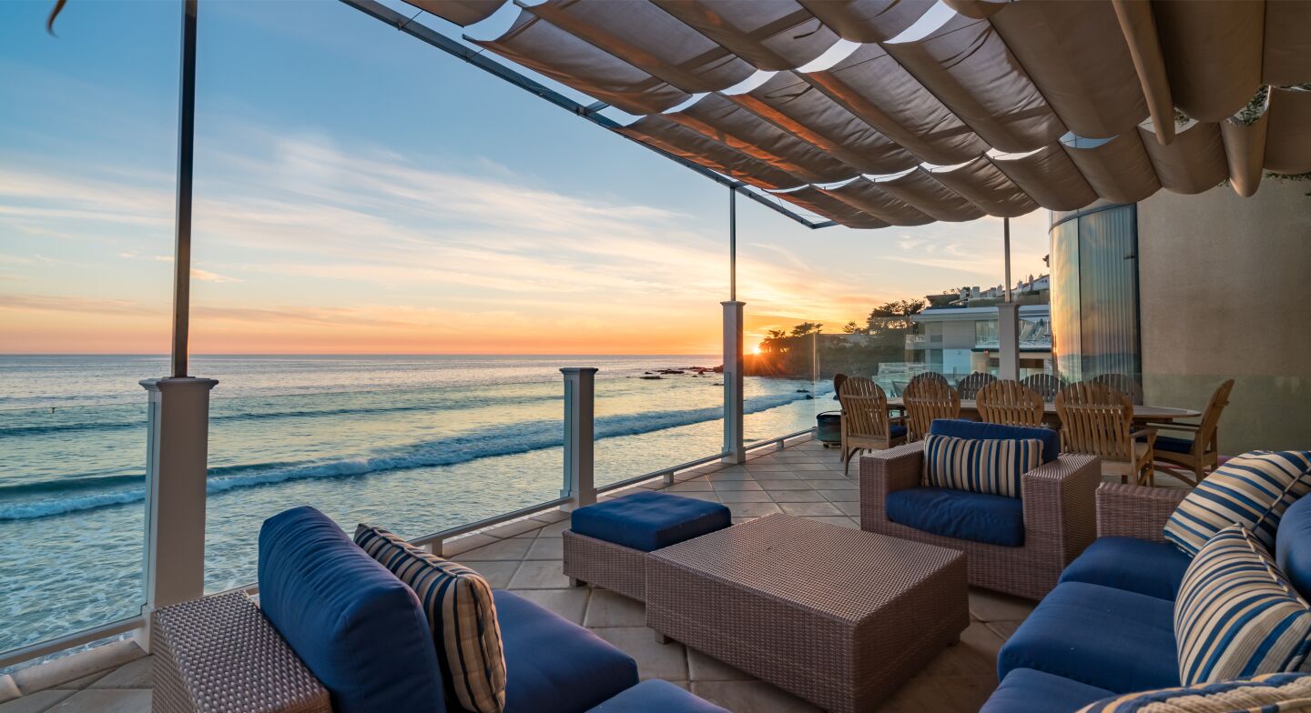 The covered furnished deck overlooks the ocean.