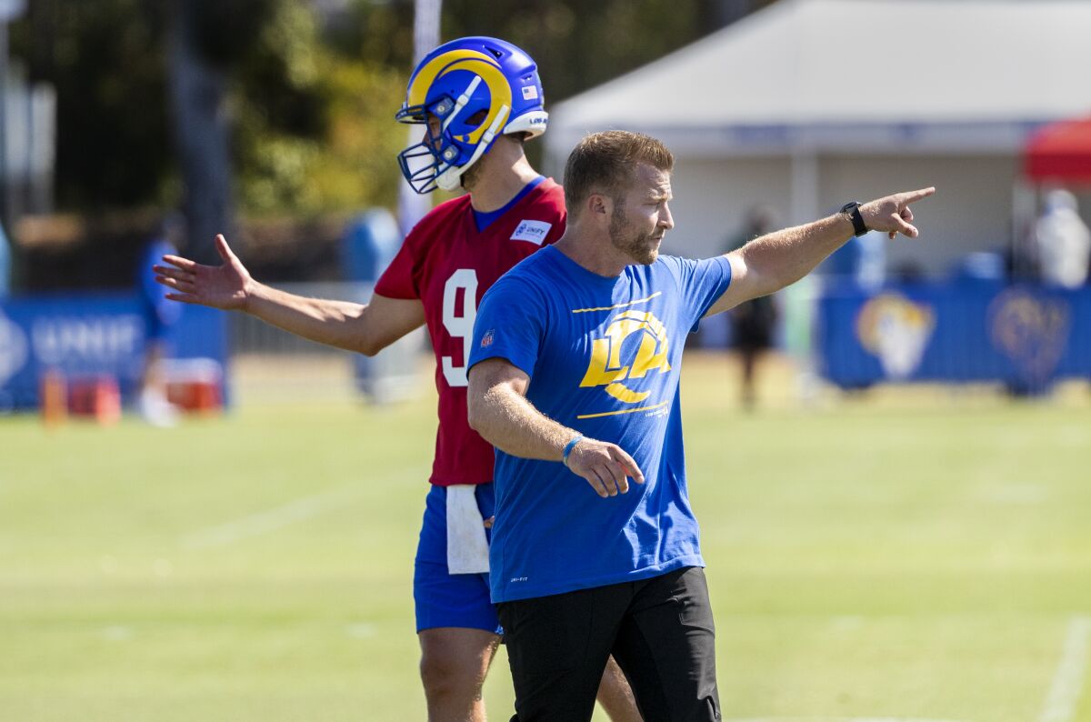 Rams coach Sean McVay and starting quarterback Matthew Stafford give direction during camp.
