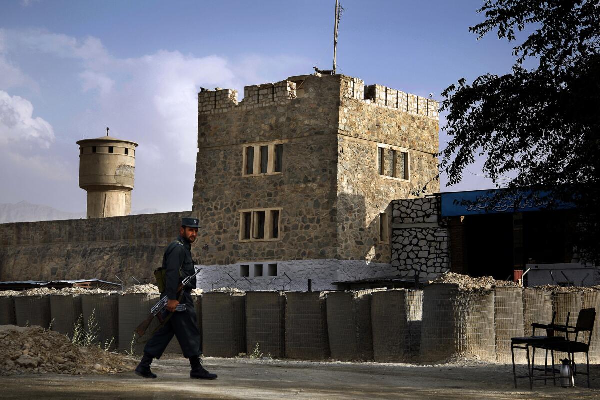 An Afghan prison guard keeps watch outside Pul-e-Charkhi Prison near Kabul. The site holds at least 1,200 prisoners, many of them former Taliban fighters.