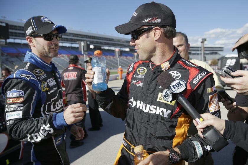 Jimmie Johnson, left, playfully interrupts fellow driver Matt Kenseth during an interview during qualifying for NASCAR Sprint Cup race at the Texas Motor Speedway in Fort Worth.