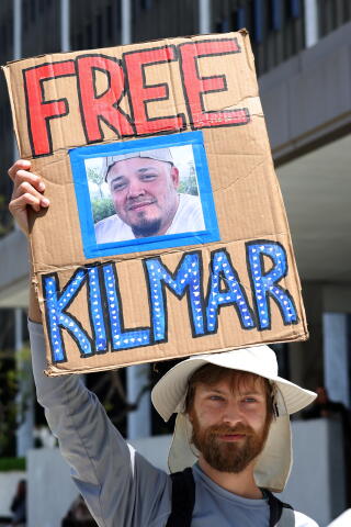Eric Kalosa-Kenyon holds a sign demanding the release of Kilmar Abrego Garcia in downtown Los Angeles on April 22.