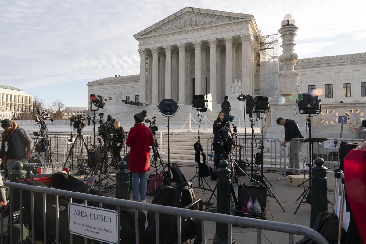 Members of the media set up outside the Supreme Court.