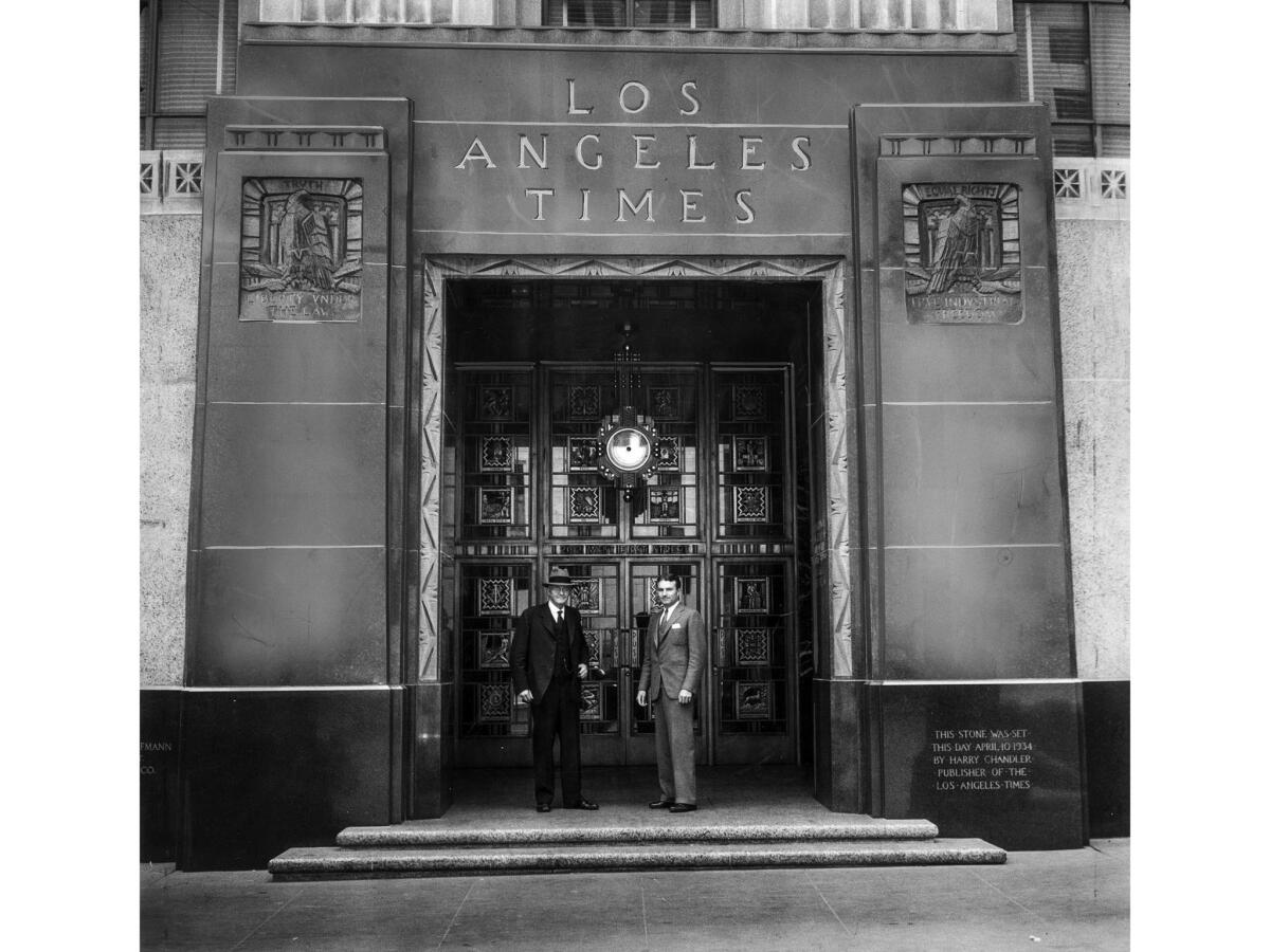 June 29, 1935: Harry Chandler, president and general manager of the Los Angeles Times, and Norman Chandler, vice-president and assistant general manager, stand at the new Los Angeles Times building's 1st Street entrance.