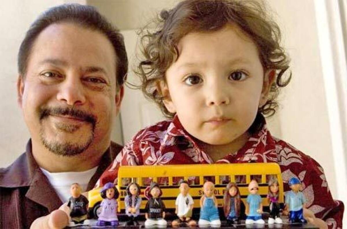 TOYS IN THE HOOD: David Gonzales, left, and his grandson display some of the plastic Homies characters, which were criticized by some as glorifying gang life.