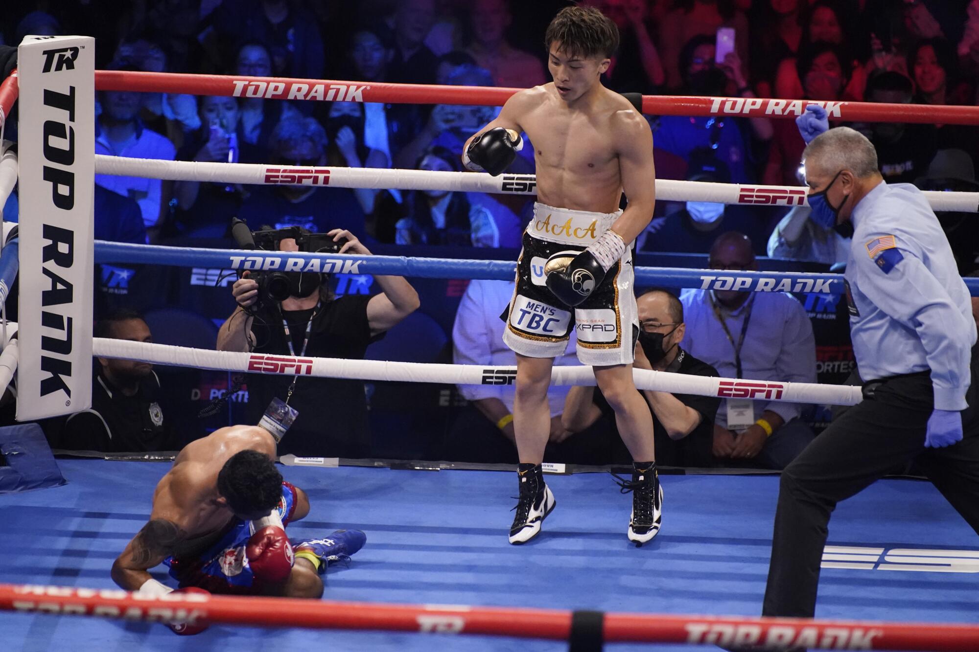 Naoya Inoue, of Japan, knocks down Michael Dasmarinas, of the Philippines