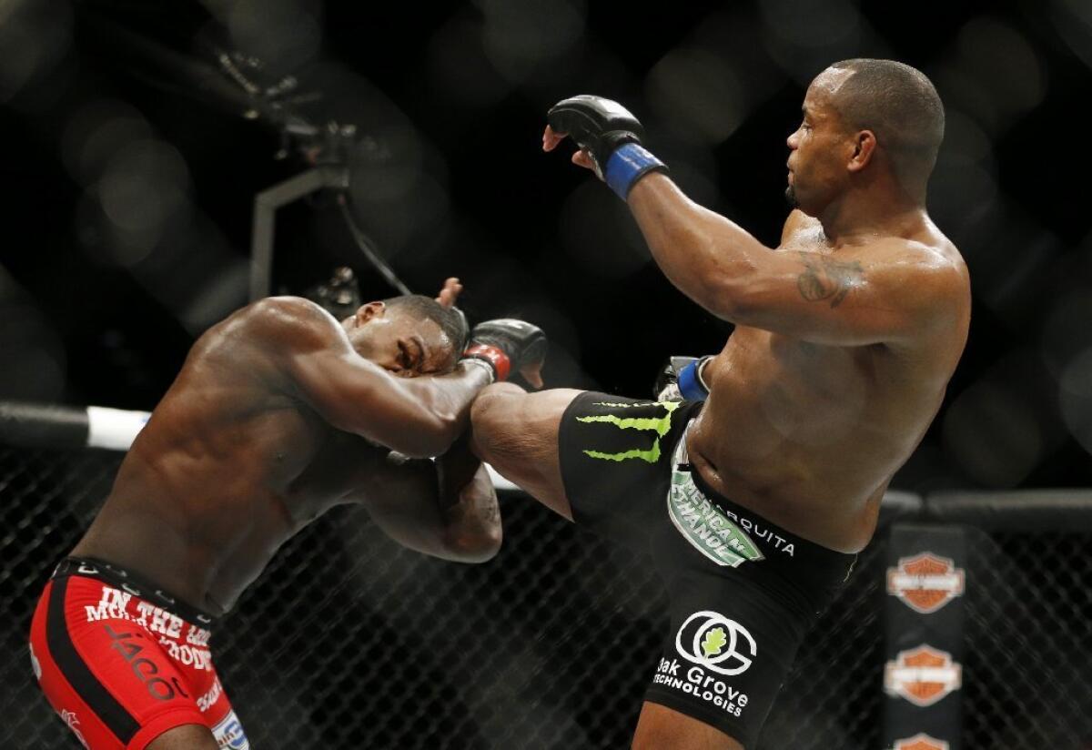 UFC light-heavyweight champion Daniel Cormier kicks Anthony Johnson during their UFC 187 bout on May 23.