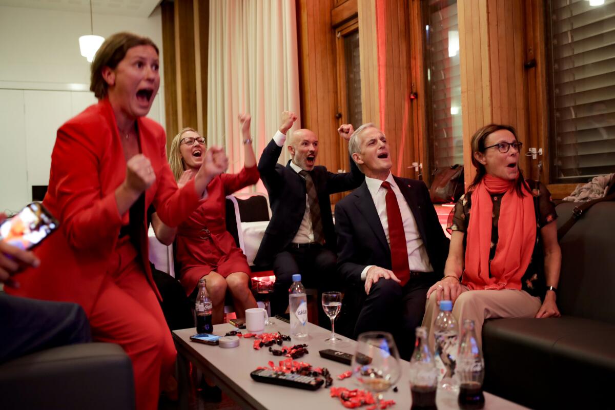 Labor leader Jonas Gahr Store cheers after seeing the exit poll during the Labor Party's election party at Folkets hus in the 2021 Norwegian parliamentary elections, in Oslo, Monday, Sept. 13, 2021. (Javad Parsa/NTB via AP)