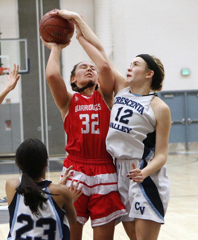 Crescenta Valley's Lily Geck blocks and fouls Burroughs' Faith Boulanger while shooting in a Pacific League girls' basketball game at Crescenta Valley High School on Tuesday, December 11, 2018.