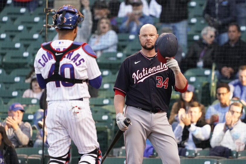 Washington Nationals' Jon Lester (34) tips his helmet as he comes to bat as Chicago Cubs catcher Willson Contreras (40) stands nearby during the second inning of a baseball game, Monday, May, 17, 2021, in Chicago. (AP Photo/David Banks)