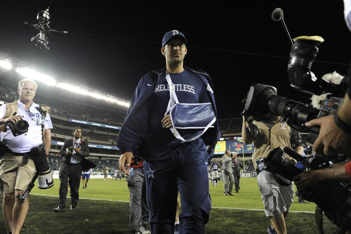 injured Dallas Cowboys quarterback Tony Romo walks off the field after an NFL football game against the Philadelphia Eagles, Sunday, Sept. 20, 2015, in Philadelphia. Dallas won 20-10. (AP Photo/Michael Perez)