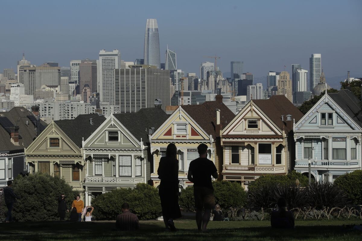 Visitors look toward the "Painted Ladies," a row of historical Victorian homes, in San Francisco.