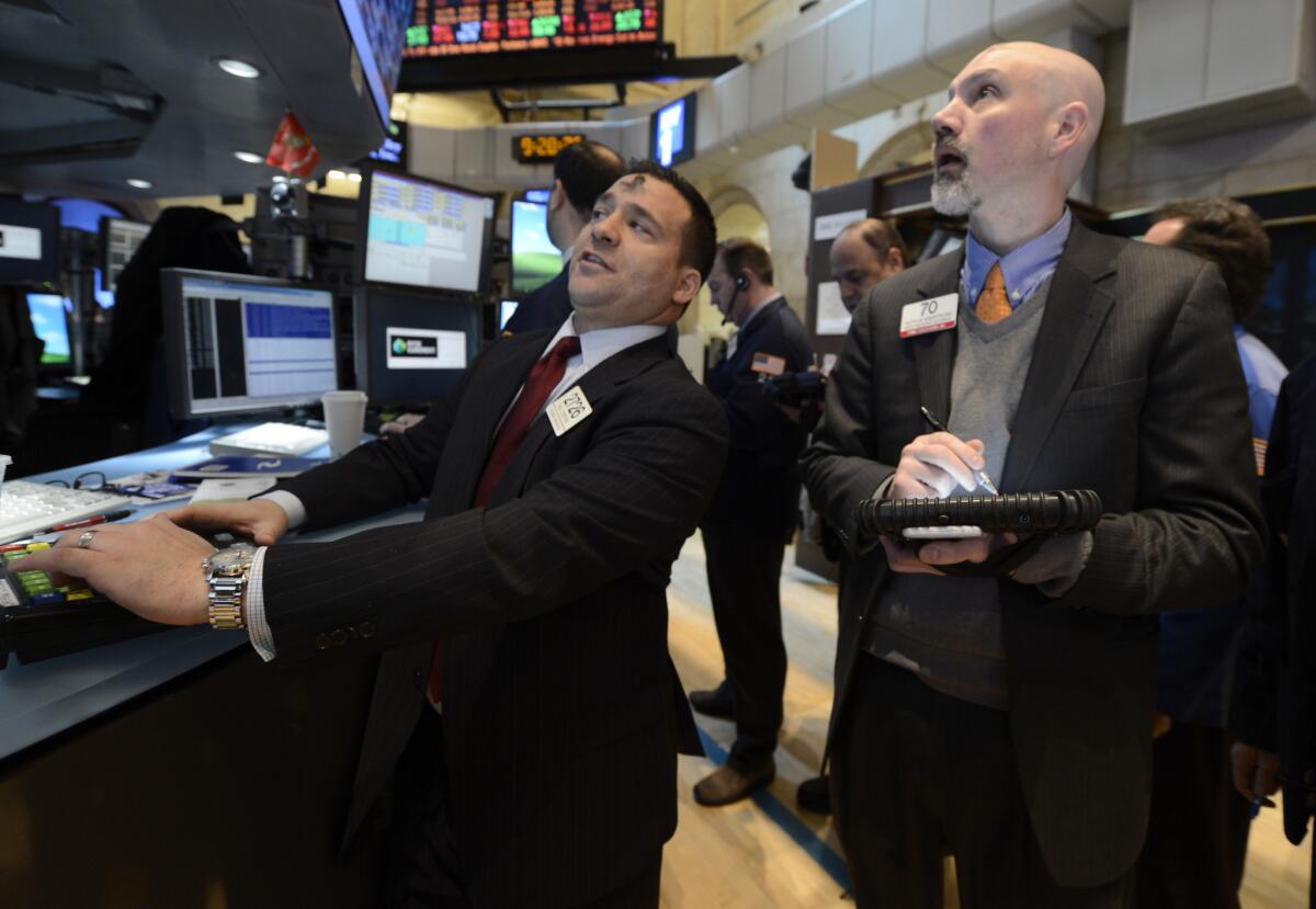 Paul Cosentino, left, of Goldman Sachs and Patrick Armstrong of Prime Executions work on the floor of the New York Stock Exchange, in New York.