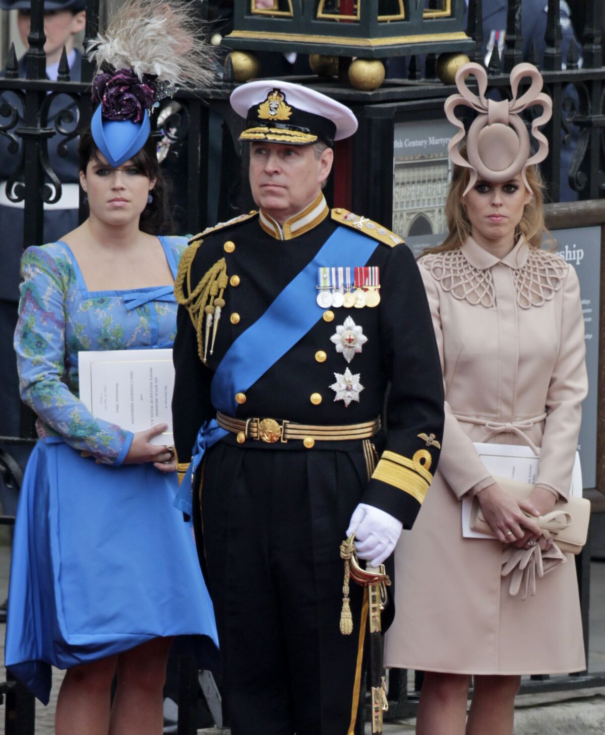 Britain's Prince Andrew and daughters Princess Eugenie, left, and Princess Beatrice leave Westminster Abbey after the 2011 royal wedding.