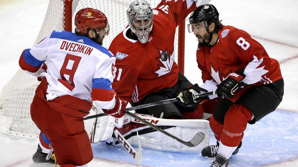 Team Canada goalie Carey Price and defenseman Drew Doughty turn away a shot by Team Russia center Alex Ovechkin during an exhibition game Sept. 14.