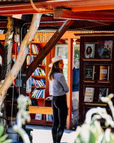 A person looks at books on shelves at Bart's Books. 