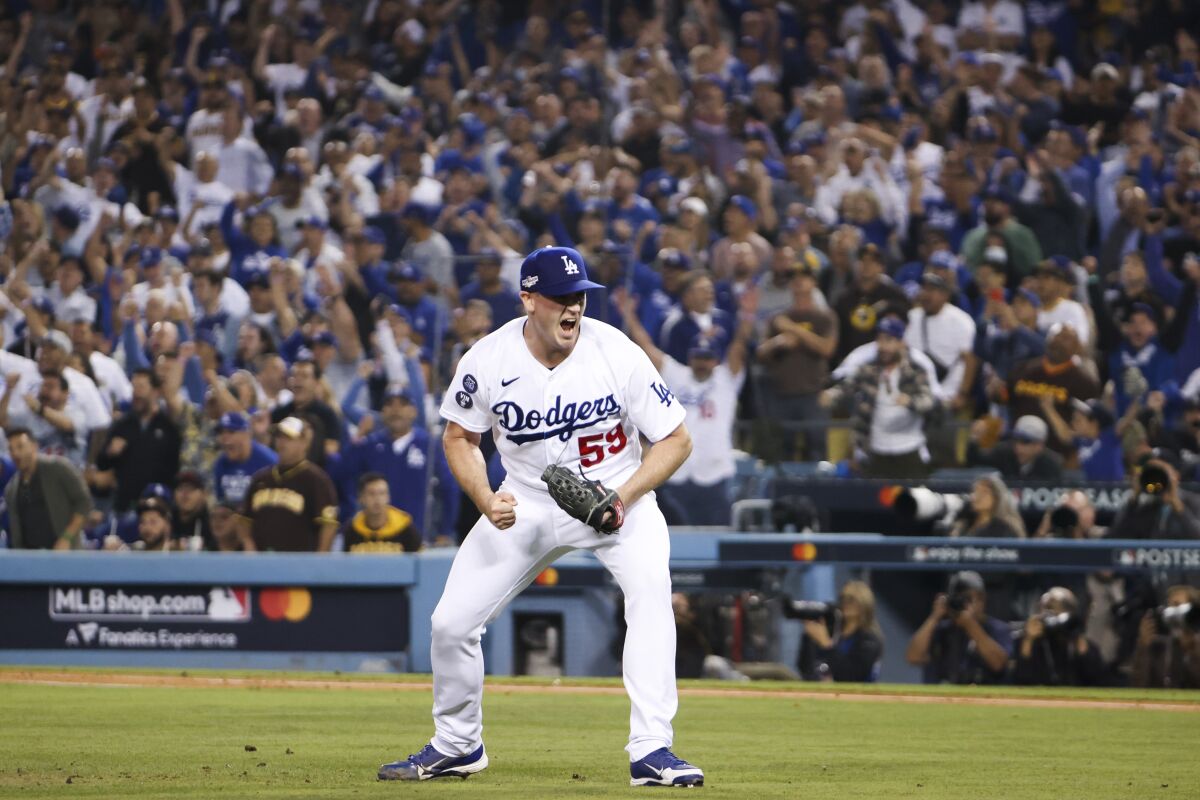 Dodgers relief pitcher Evan Phillips celebrates after San Diego's Wil Myers is grounded in a doubles game.