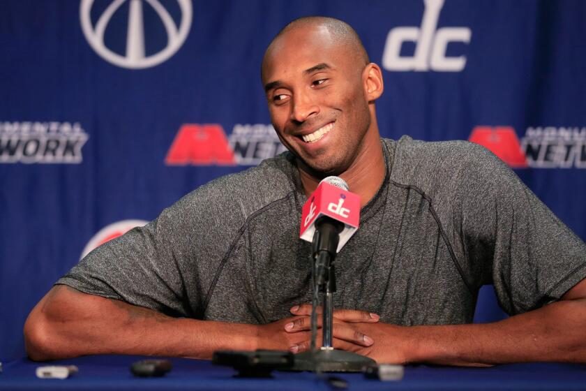 Kobe Bryant talks with the media during a news conference before the start of the Lakers and Washington Wizards.