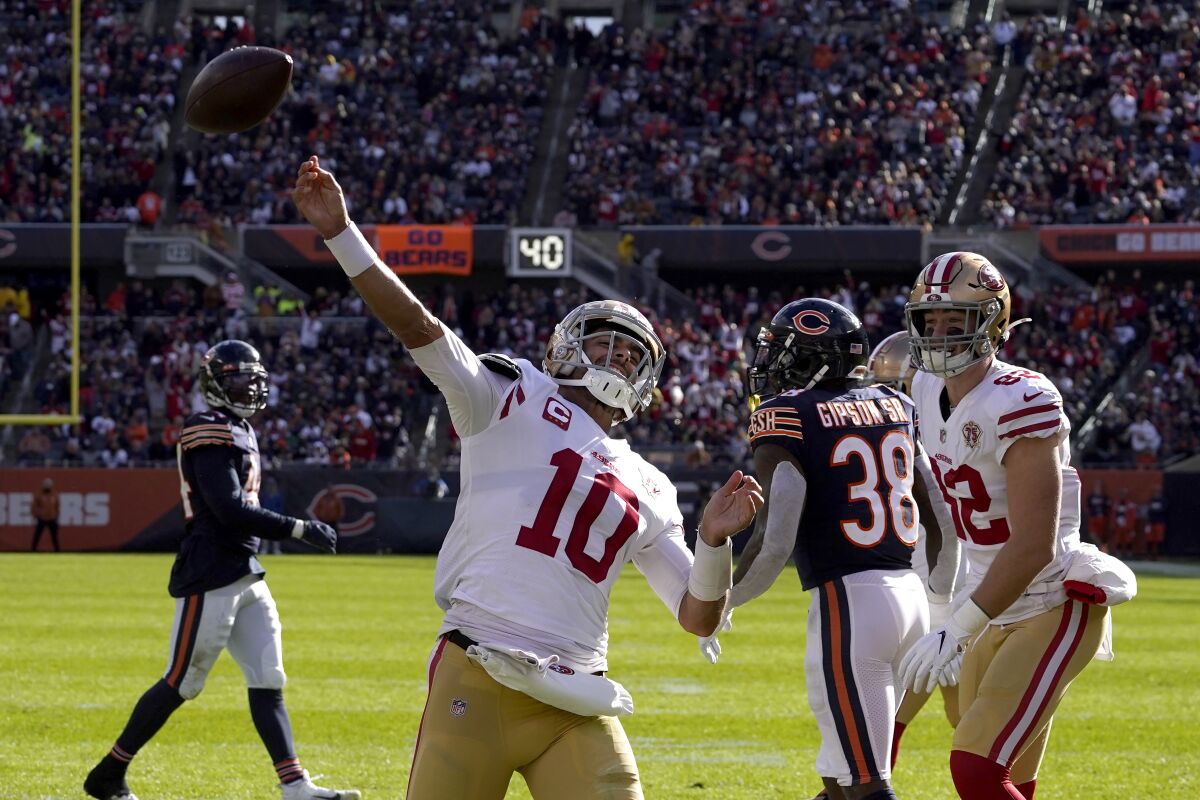 San Francisco 49ers quarterback Jimmy Garoppolo celebrates his touchdown during the second half of an NFL football game against the Chicago Bears Sunday, Oct. 31, 2021, in Chicago. (AP Photo/Nam Y. Huh)
