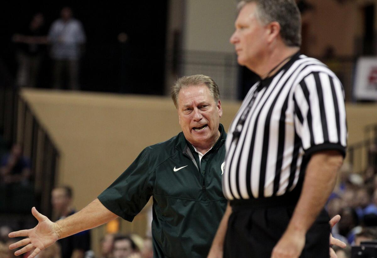Michigan State Coach Tom Izzo, left, talks to referee Karl Hess during the second half of a game on Nov. 30.