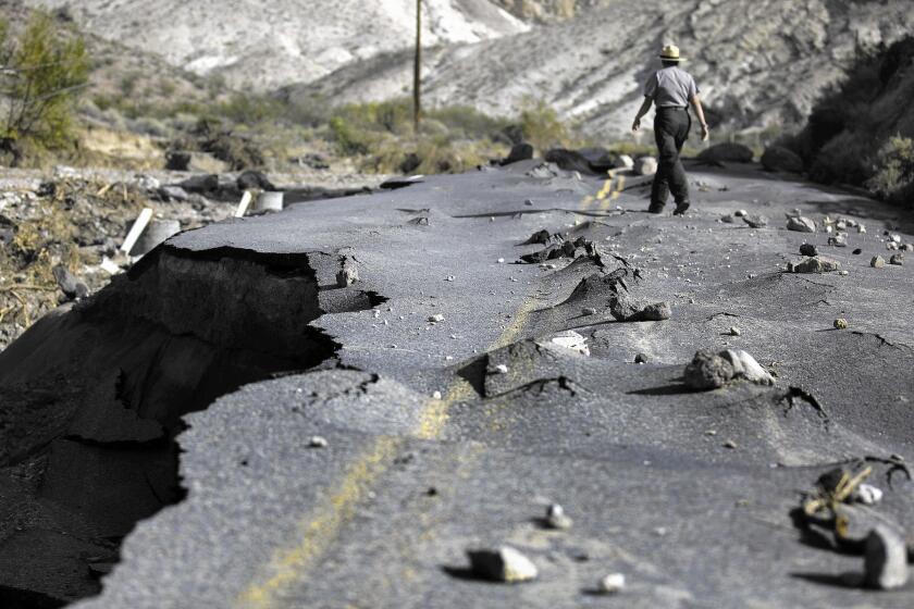 A 100-yard-long section of newly paved Highway 267 in Grapevine Canyon, a two-lane road designed to withstand severe flooding, was lifted up by roiling water and then slammed down on boulders in Death Valley National Park.