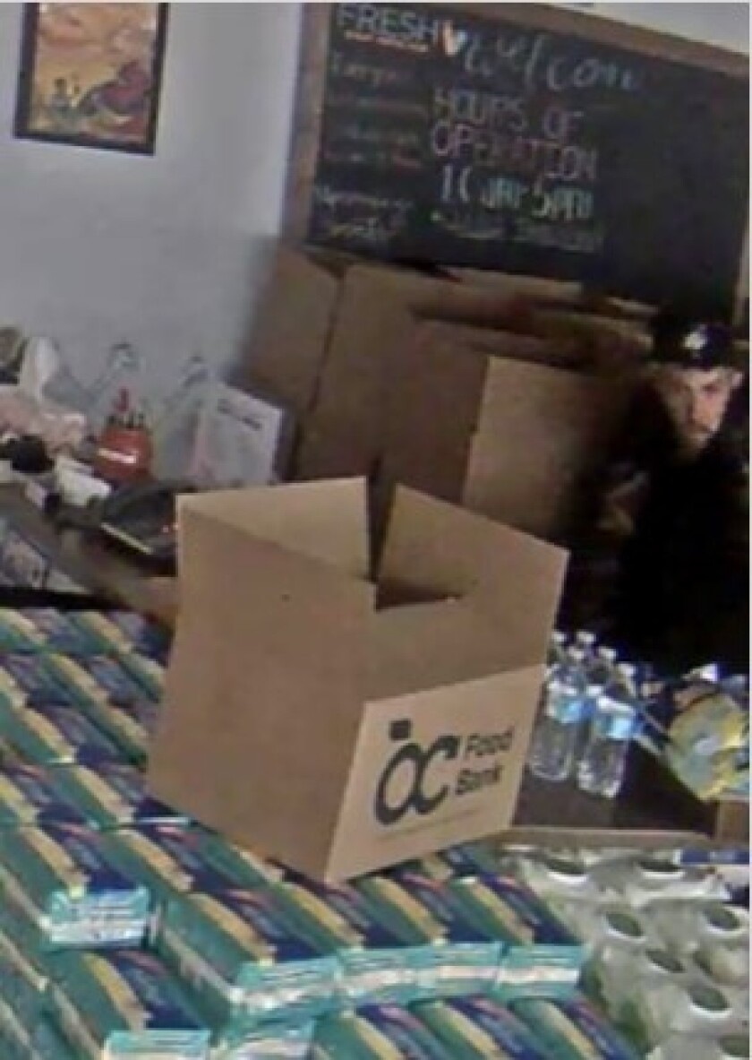 An image from a surveillance camera shows a man who UC Irvine police believe burglarized the Fresh Basic Needs Hub at the university on Saturday.